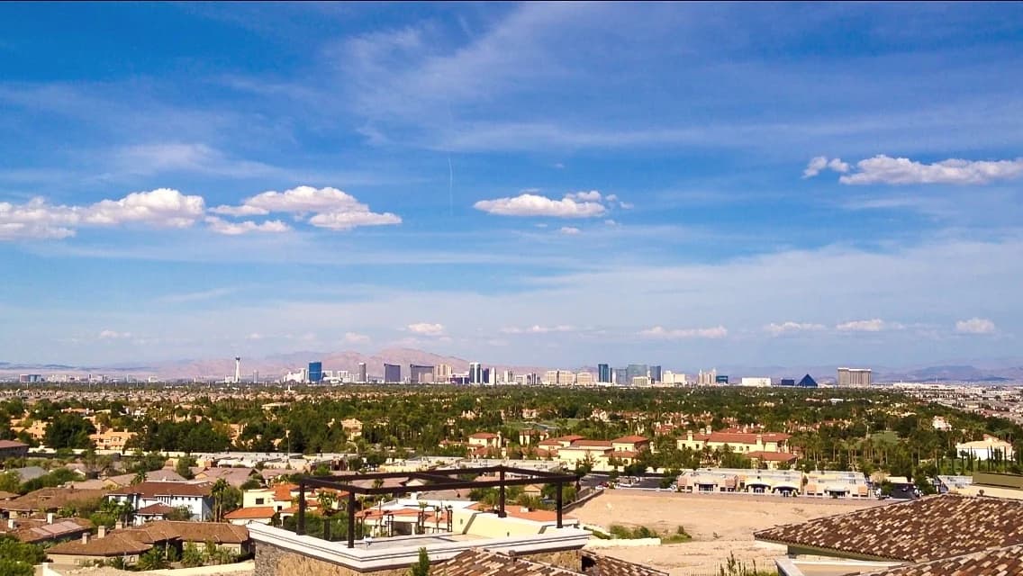 Spring Valley homes and trees with the Las Vegas skyline beyond, seen from Spanish Hills