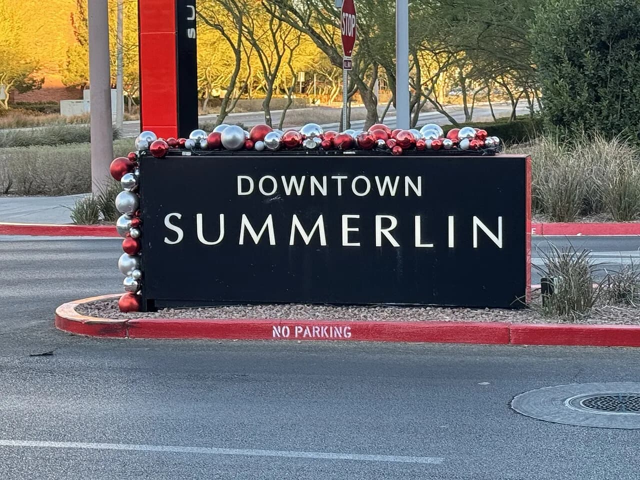 Downtown Summerlin sign with holiday ornaments and desert landscaping