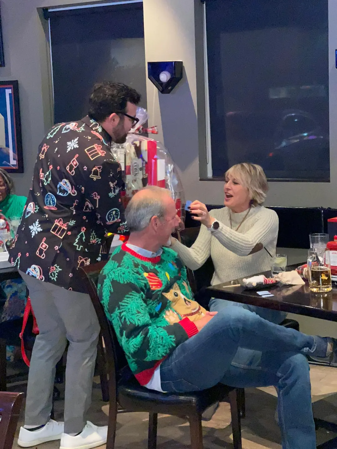 Guests laugh together during the Christmas party.
