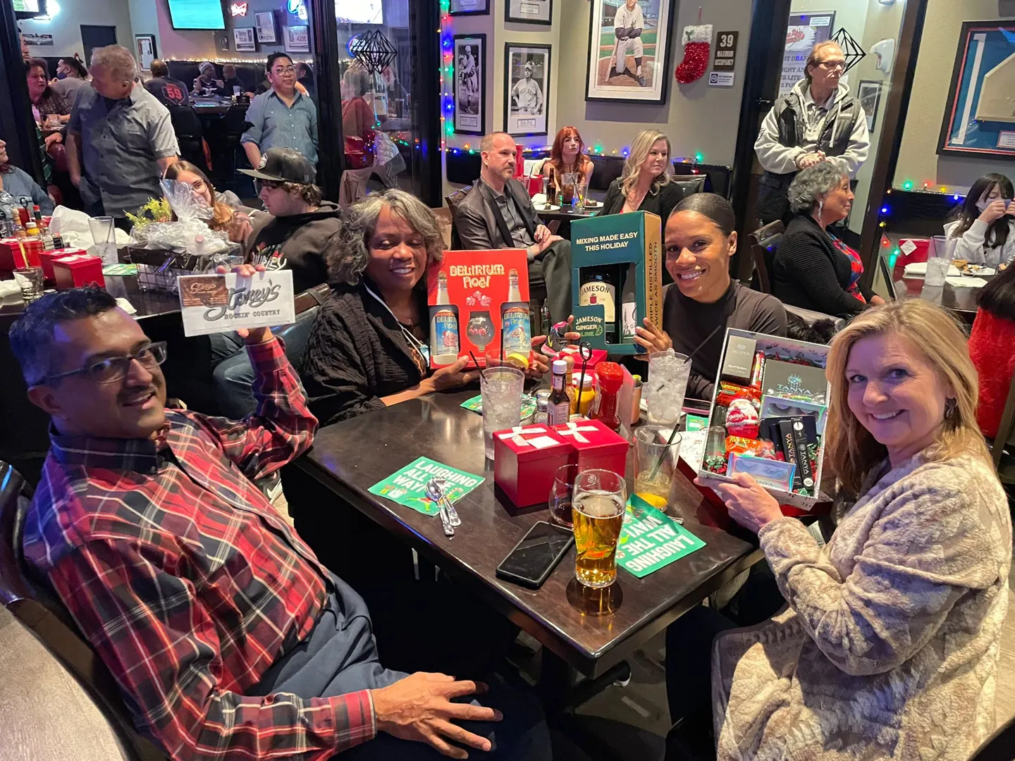 Guests gather around a table at the holiday party.