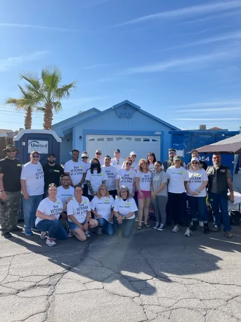 Volunteers gather outside a home during Rebuilding Together in April 2022.