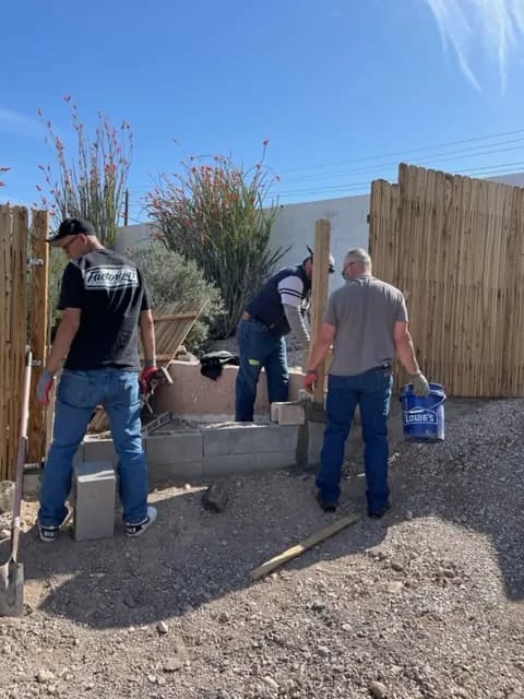 Volunteers work together in a yard.
