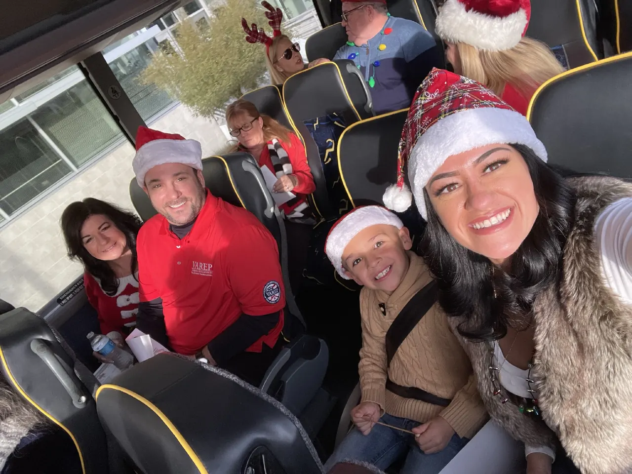 Participants wearing festive hats aboard a bus during Sgt. Santa 2022.