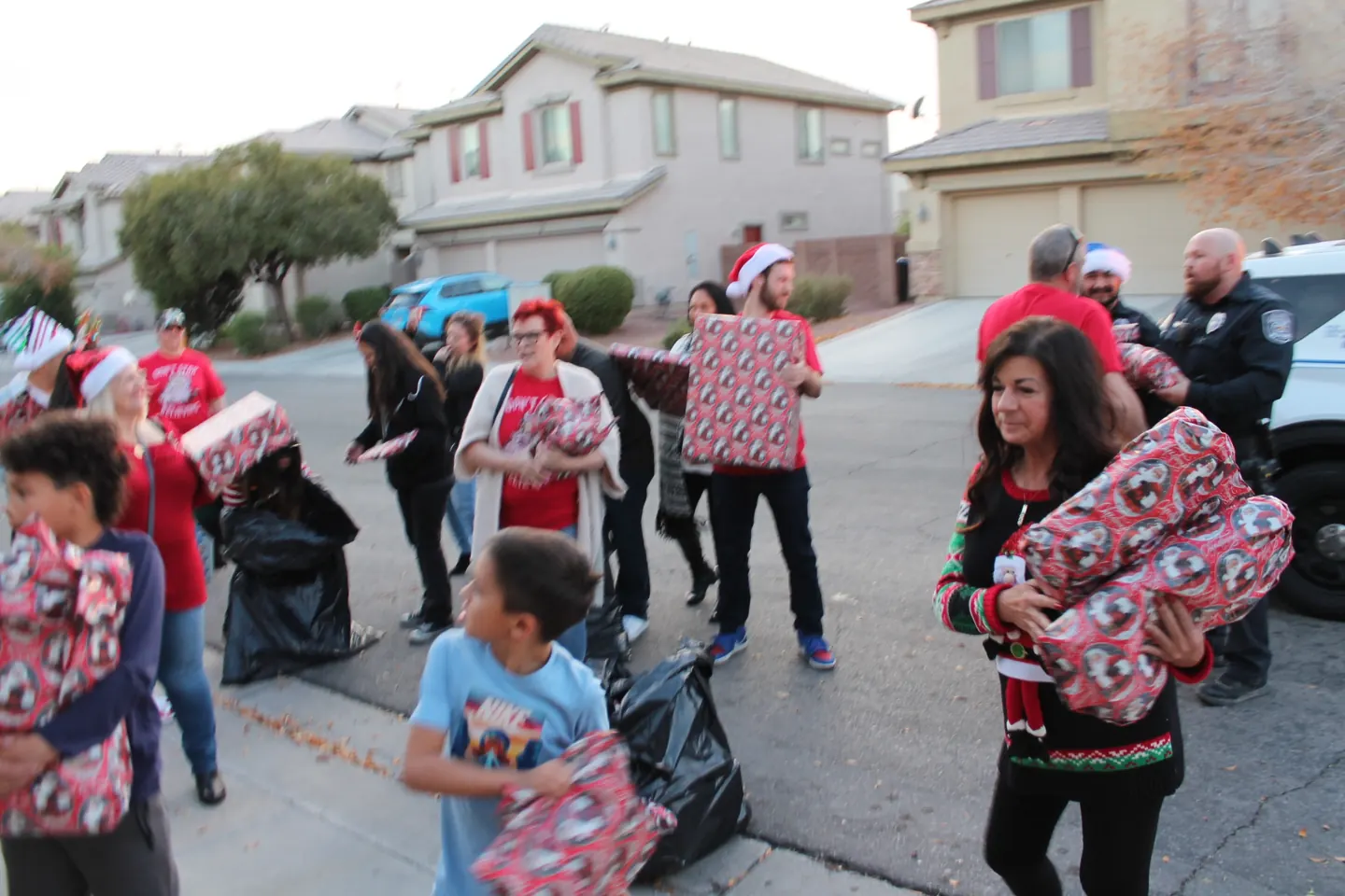 Participants carry wrapped gifts during the Sgt. Santa gathering.