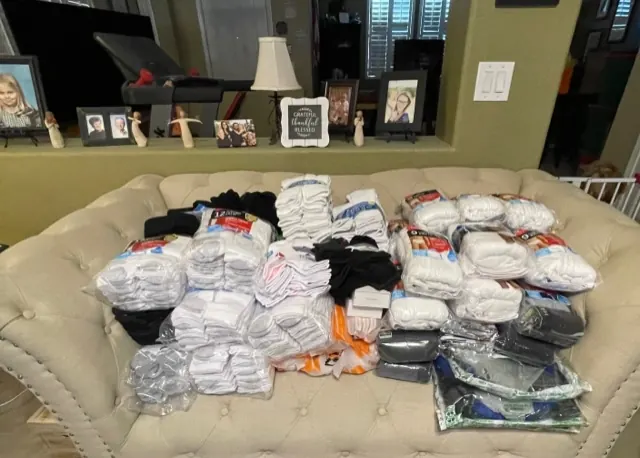 Packages of socks and other clothing arranged together for the drive.