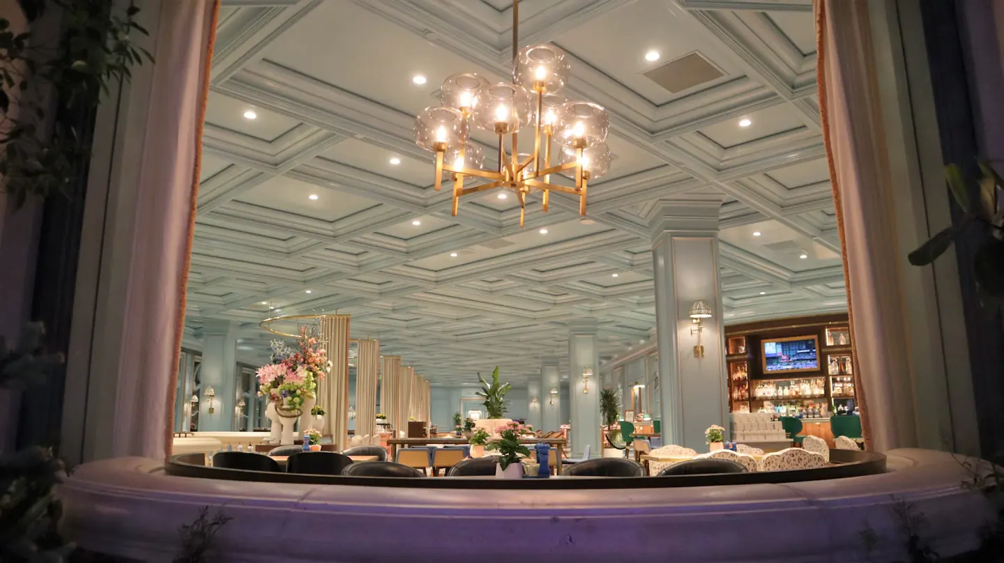 Las Vegas restaurant interior with chandeliers, seating and a bar